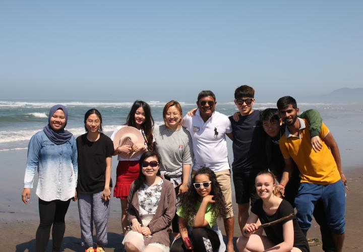 PSU international students standing as a group on the beach.