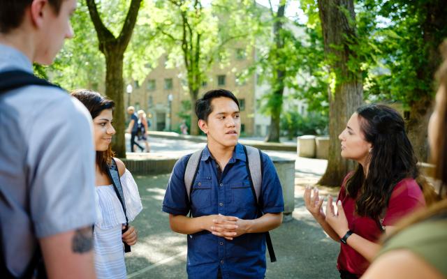 Members of student government having a conversation in the park blocks.