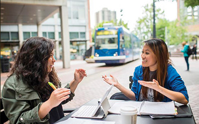 Students talking while studying in the Urban Plaza